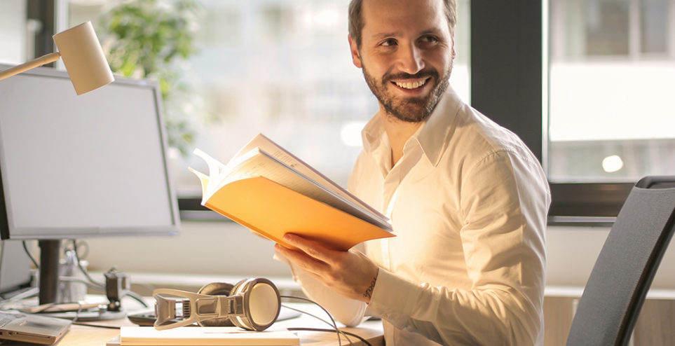 photo-of-man-holding-a-book-927022