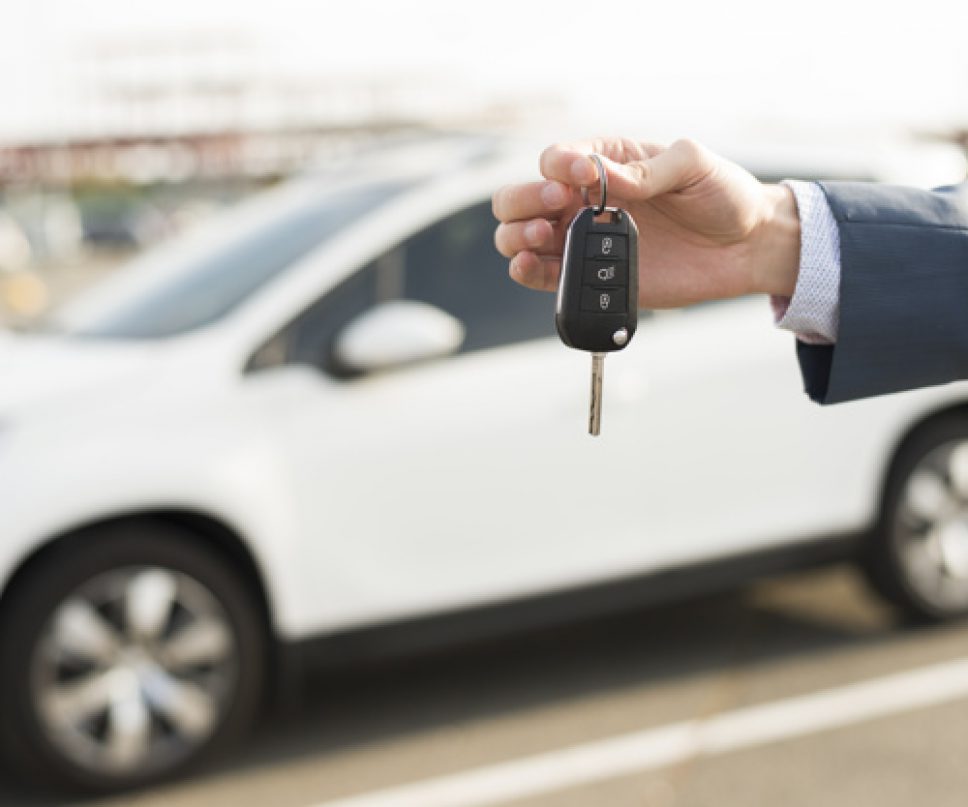 businessman-with-keys-front-car_23-2147986531