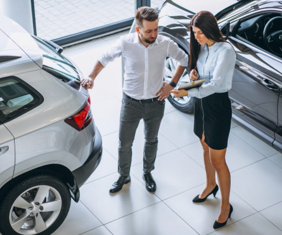 salesman-woman-looking-car-car-showroom_1303-13643