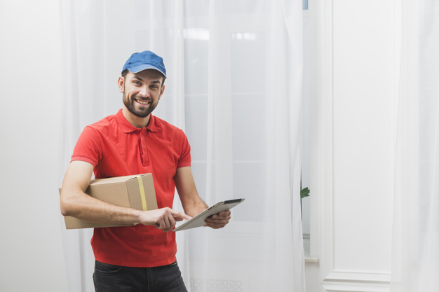 cheerful-delivery-man-with-tablet-box_23-2147801215