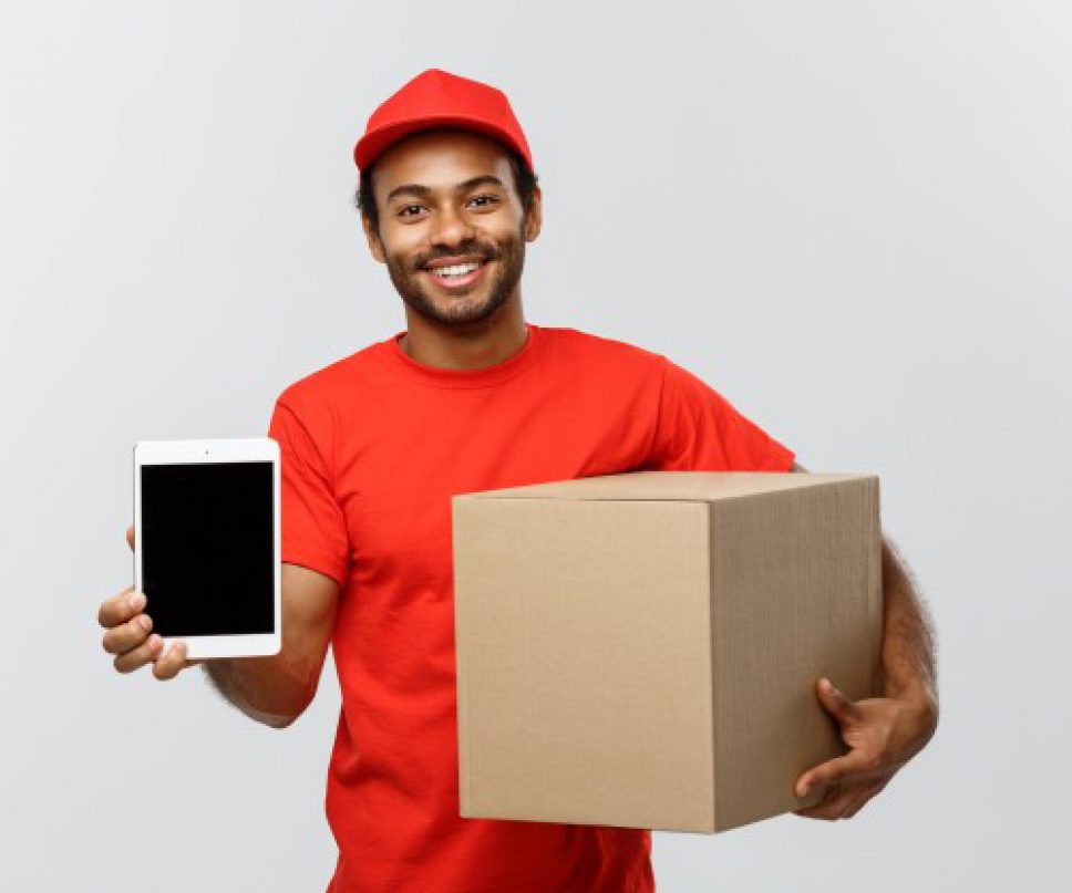 delivery-concept-portrait-handsome-african-american-delivery-man-courier-with-box-showing-tablet-you-check-order-isolated-grey-studio-background-copy-space_1258-1204