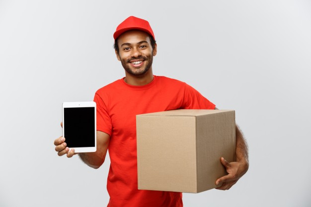 delivery-concept-portrait-handsome-african-american-delivery-man-courier-with-box-showing-tablet-you-check-order-isolated-grey-studio-background-copy-space_1258-1204