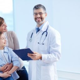 happy-doctor-holding-clipboard-with-patients_1098-2176