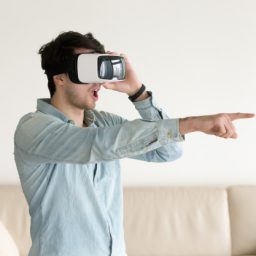 excited-young-guy-experiencing-virtual-reality-wearing-vr-headse_1163-5265