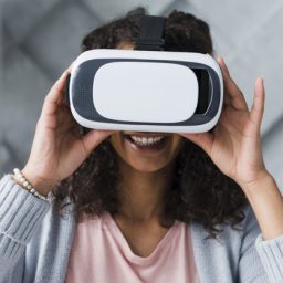 smiling-ethnic-woman-employee-using-vr-glasses_23-2148180723