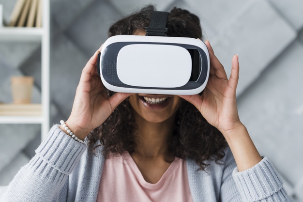 smiling-ethnic-woman-employee-using-vr-glasses_23-2148180723