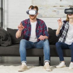 young-couple-wearing-virtual-reality-goggles-touching-air-with-hands_23-2148049015