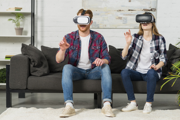 young-couple-wearing-virtual-reality-goggles-touching-air-with-hands_23-2148049015