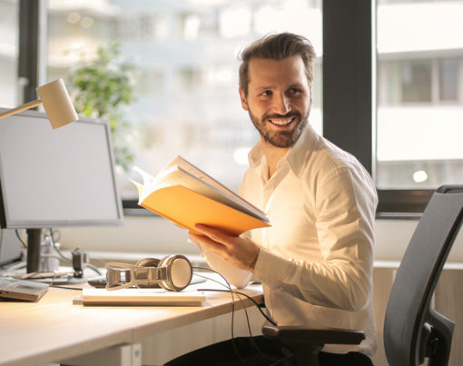 photo-of-man-holding-a-book-927022