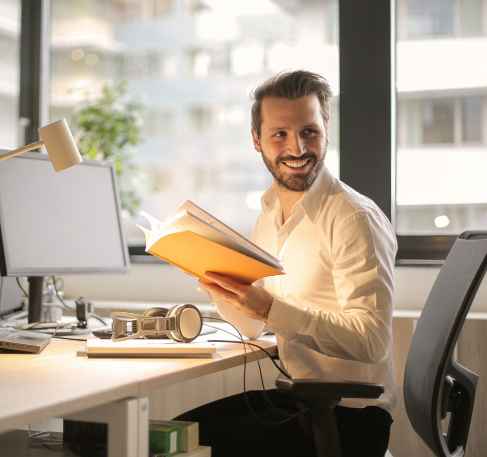 photo-of-man-holding-a-book-927022