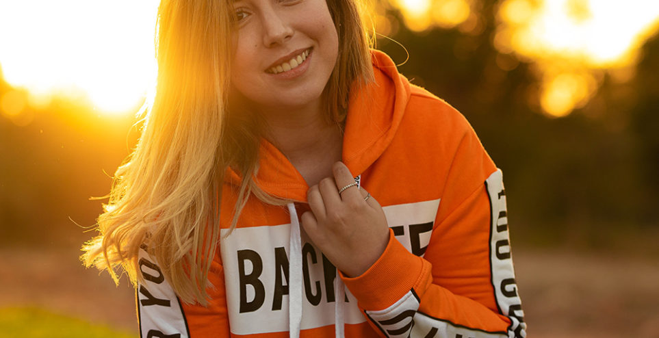 woman-in-orange-and-white-hoodie-smiling-3641193
