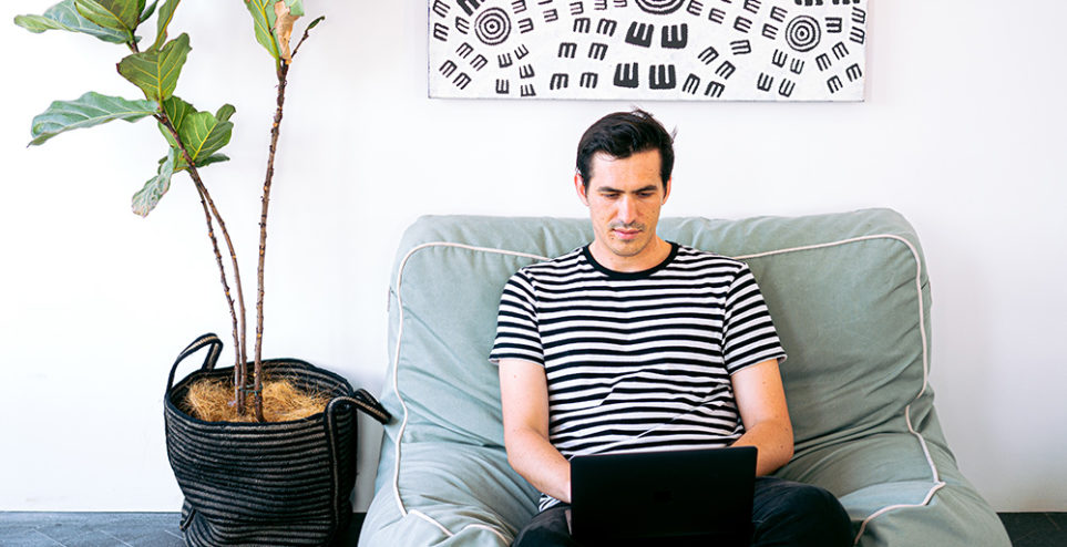 man-sitting-cozy-while-working-on-his-laptop-3153203