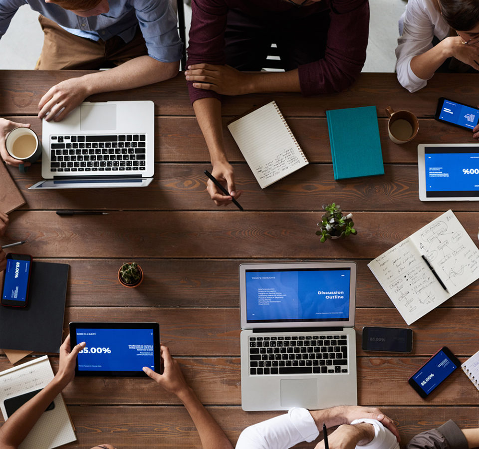 top-view-photo-of-people-near-wooden-table-3183150