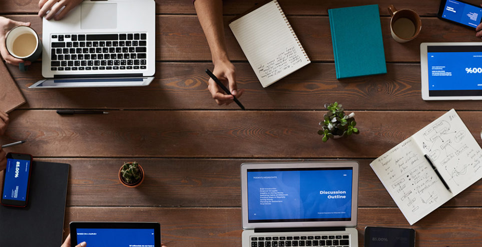 top-view-photo-of-people-near-wooden-table-3183150