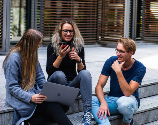 three-persons-sitting-on-the-stairs-talking-with-each-other-1438072