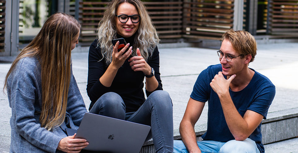 three-persons-sitting-on-the-stairs-talking-with-each-other-1438072